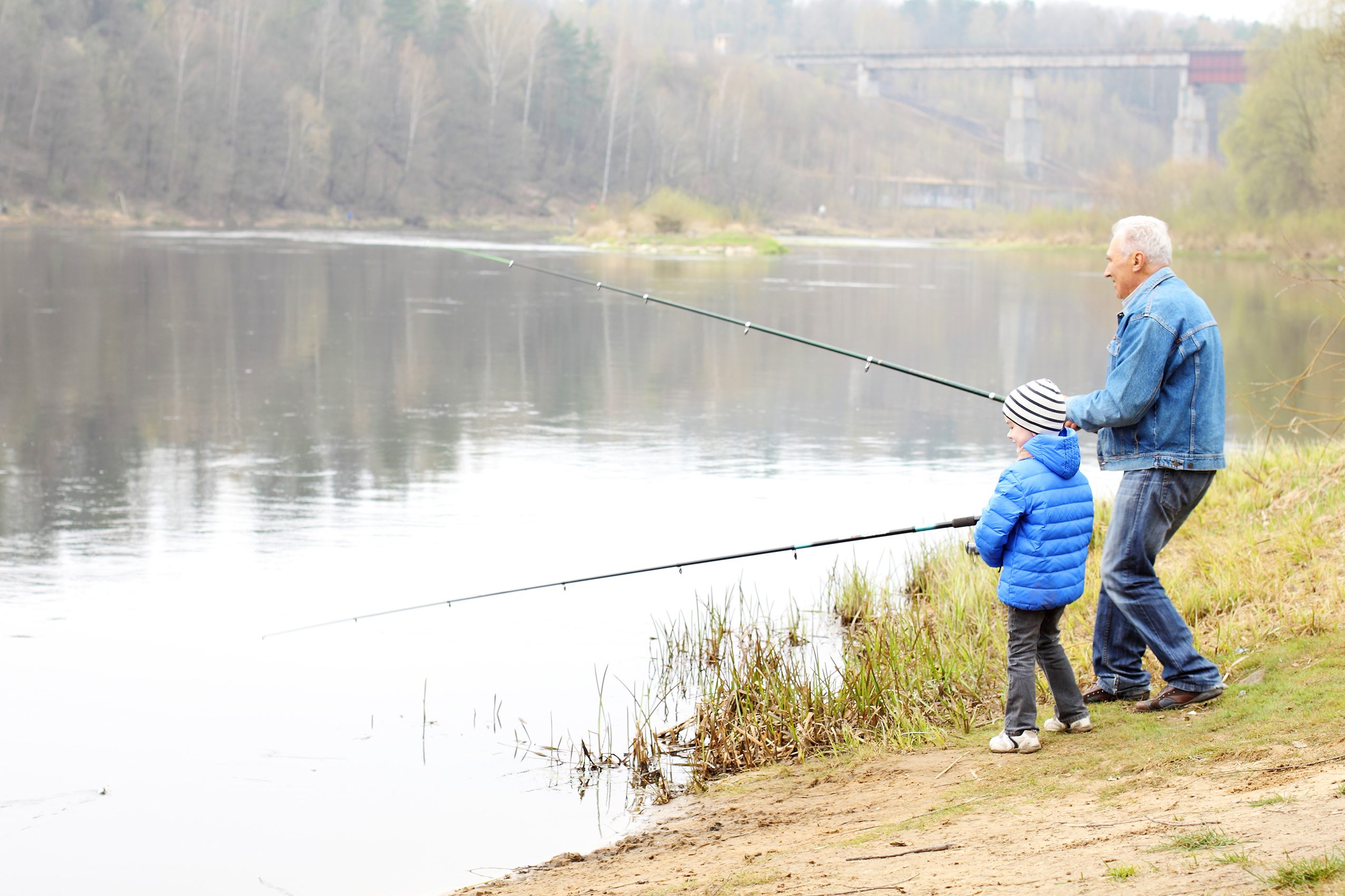 Grandfather and grandson are fishing